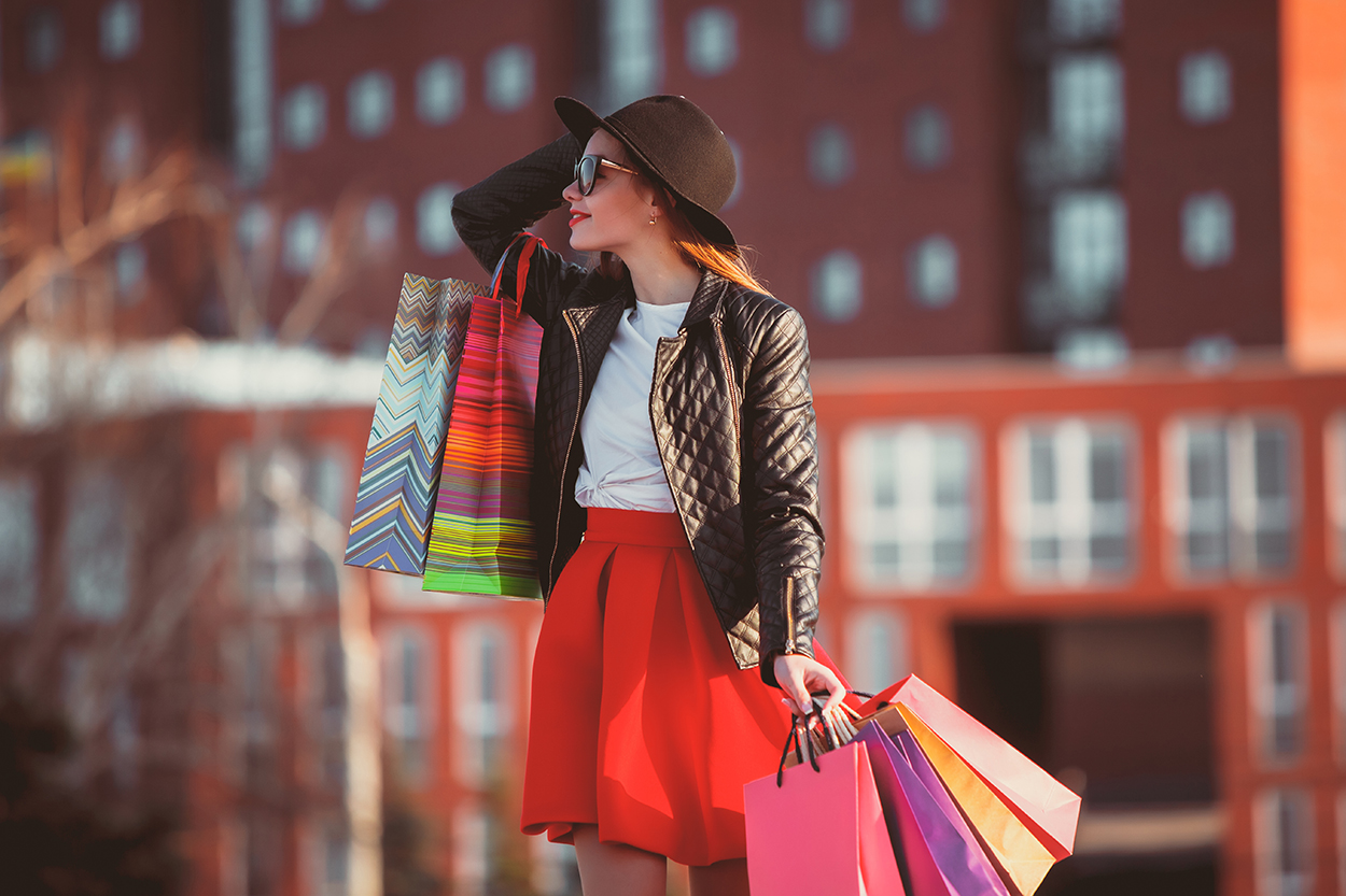 The Modern Femme Sales -The Modern Femme Sales girl walking with shopping bags city streets sunny day